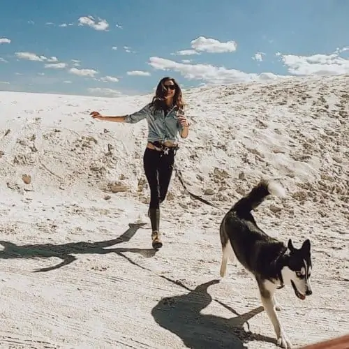 Girl and dog sunning in the sand