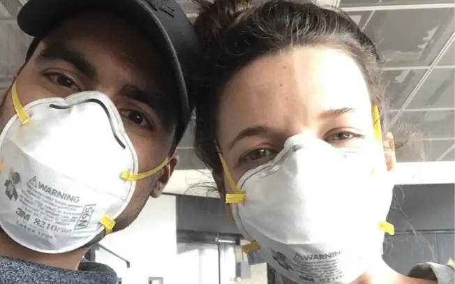Man and woman wearing N95 masks